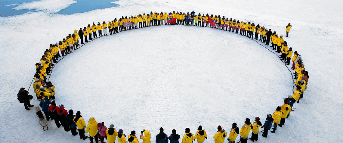 The Unstoppables forming a circle on the ice in Antarctica